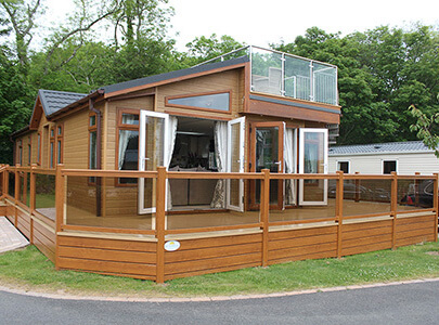 AB Sundecks Picket Glass with Decking and Steps. With balcony on top of Holiday Home with Steel Top Glass